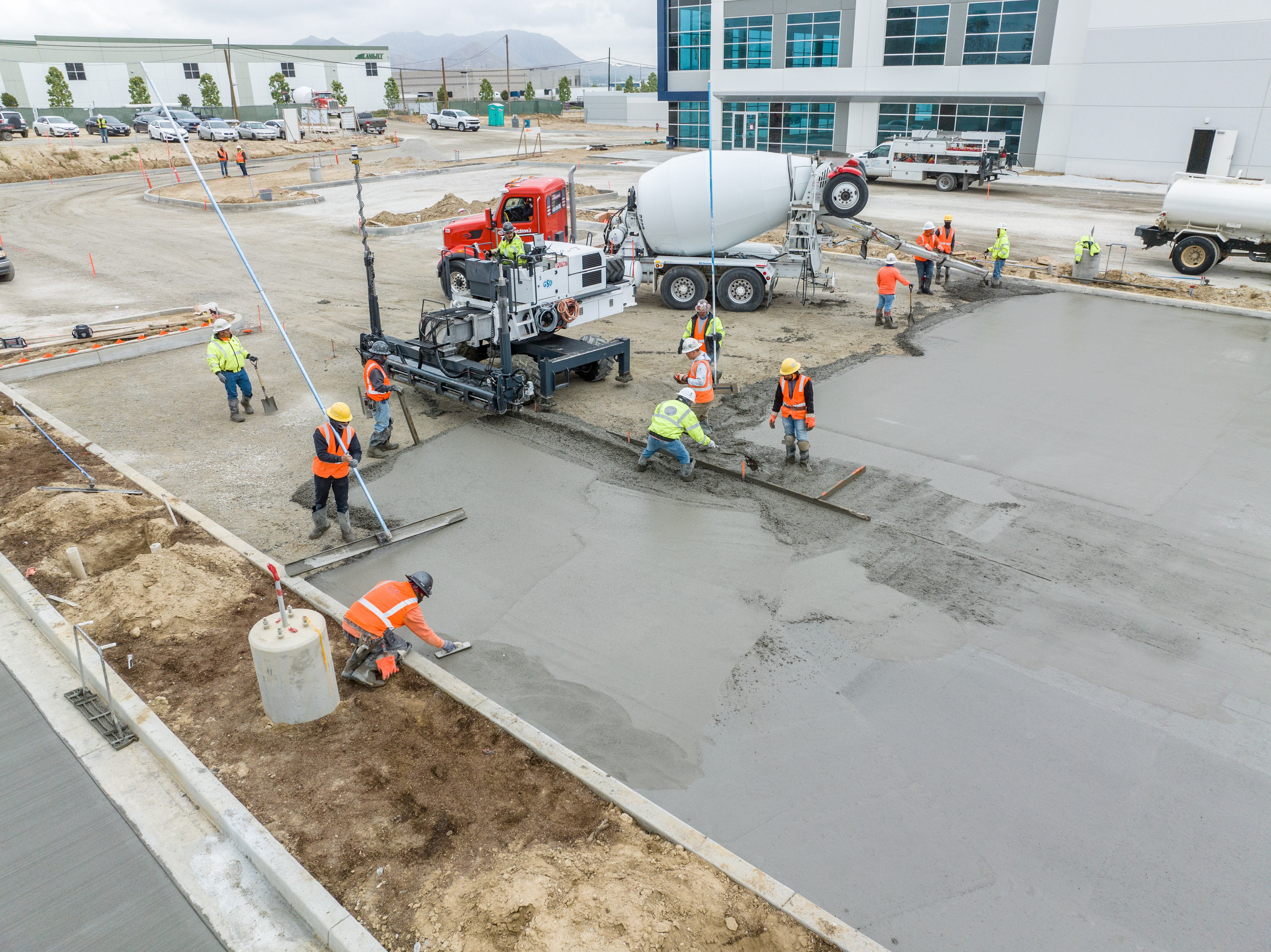 workers pouring concrete parking lot