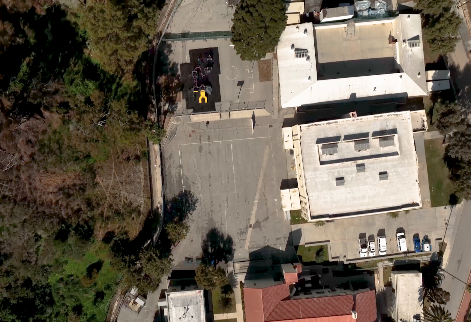 overhead view of buildings and asphalt playground