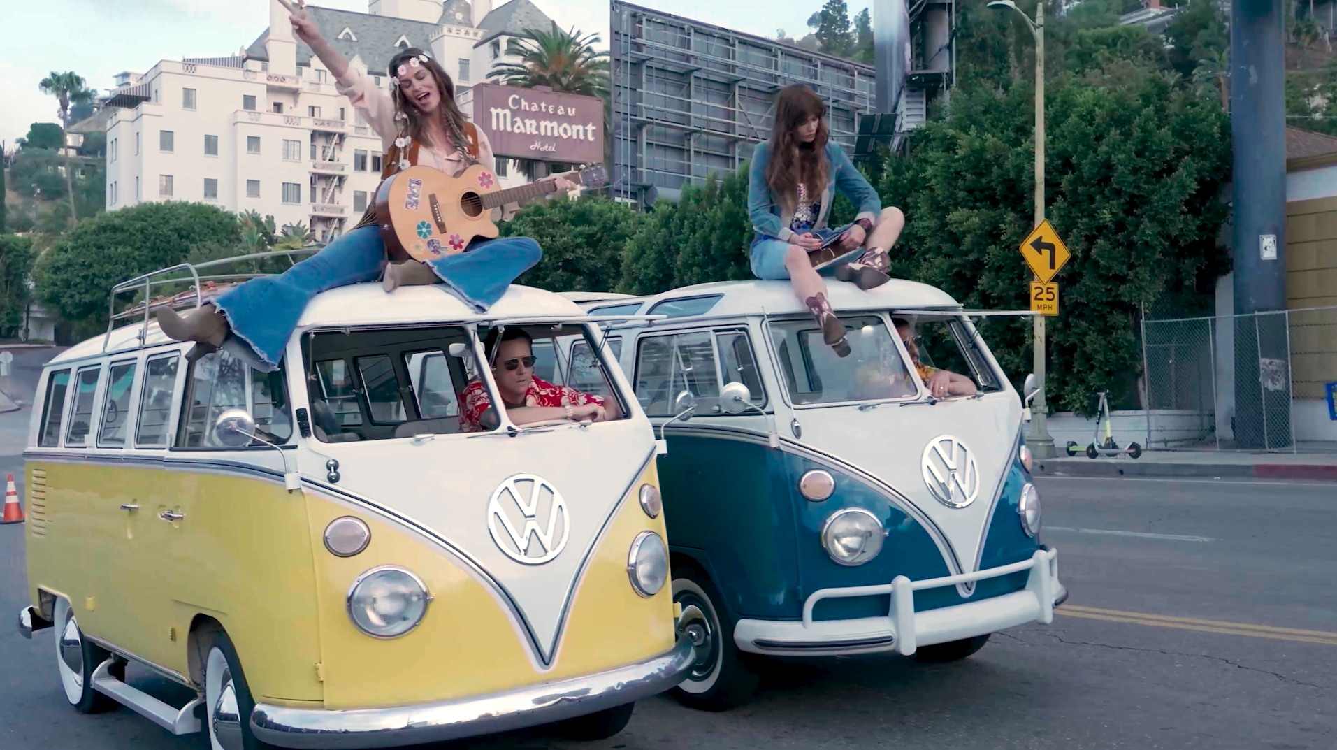 two VW vans with women on top