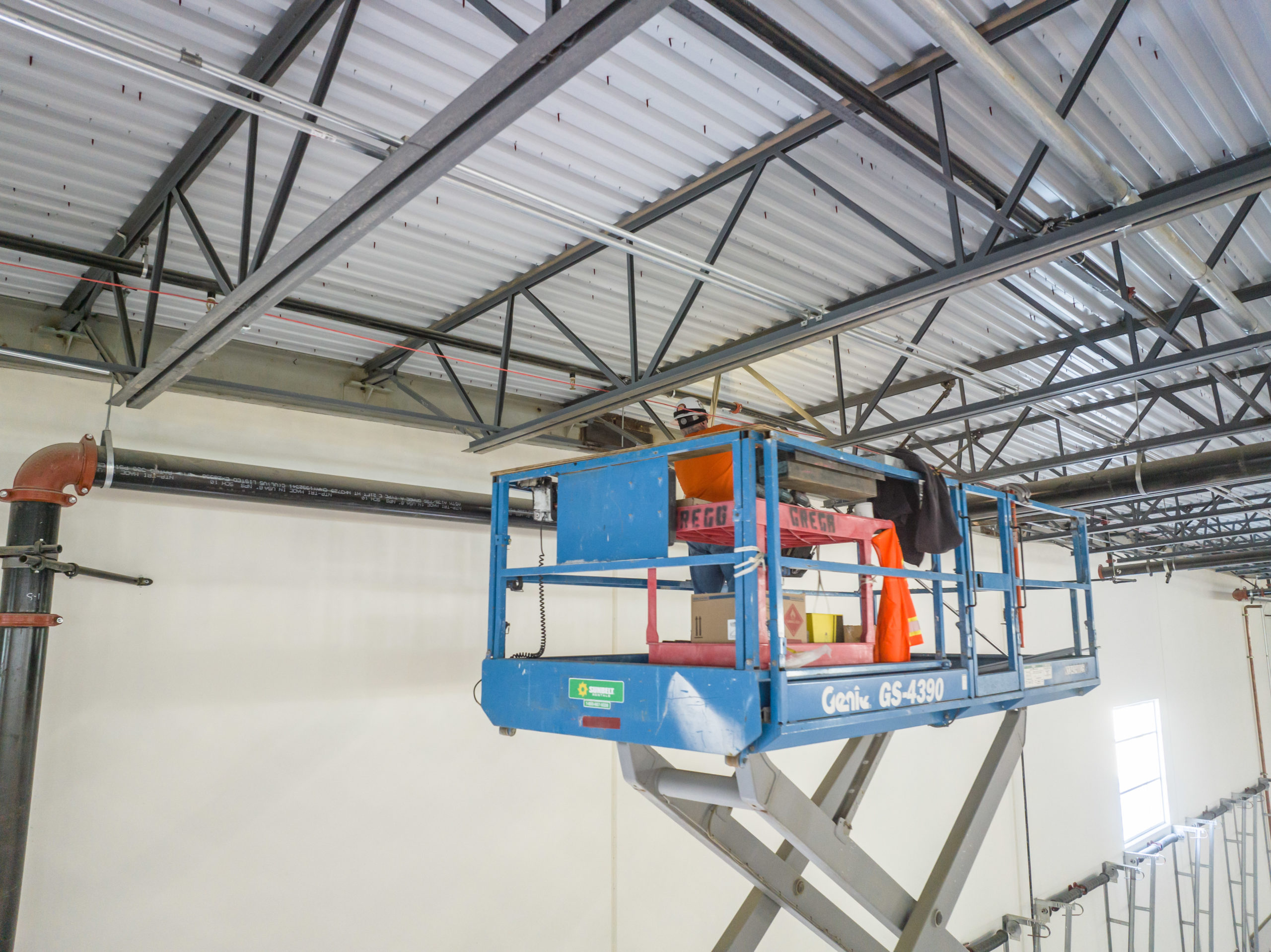 Worker inspecting inside of roof trusses