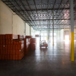 forklift backlit by sun shinning thru windows at Agua Mansa construction site