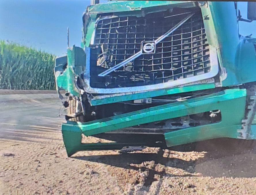 Crashed front of a semi truck that collided with 2 cows in the dark